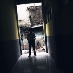 Full length rear view of man walking in building