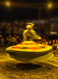 Blurred motion of man with yellow umbrella