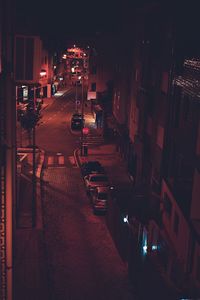High angle view of illuminated street amidst buildings at night