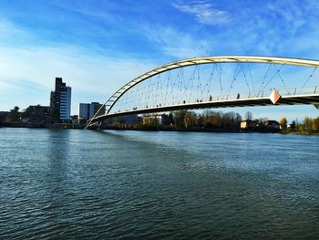 Bridge over river with city in background