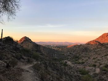 Scenic view of mountains against sky at sunset