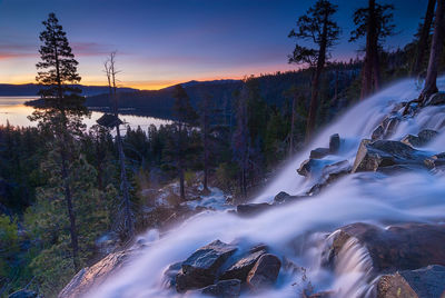 Scenic view of river against sky during sunset