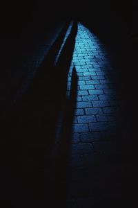 High angle view of shadow on footpath at night