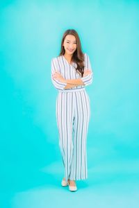 Woman standing against blue background