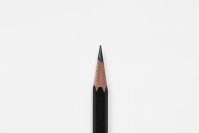 High angle view of colored pencils against white background