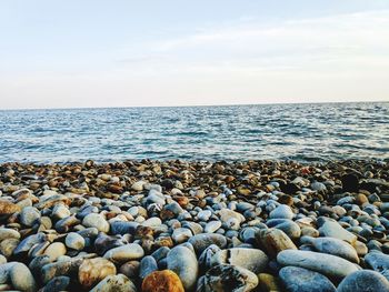 Rocks on beach against sky