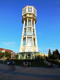 Bicycle in city against blue sky