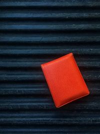 Directly above shot of wallet on black corrugated iron
