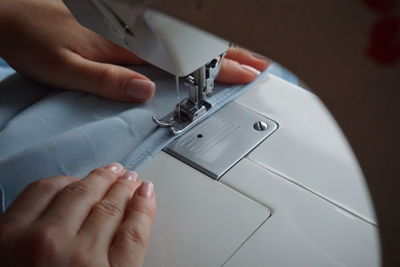Cropped image of woman sewing garment