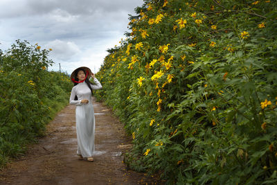 Woman standing on tree