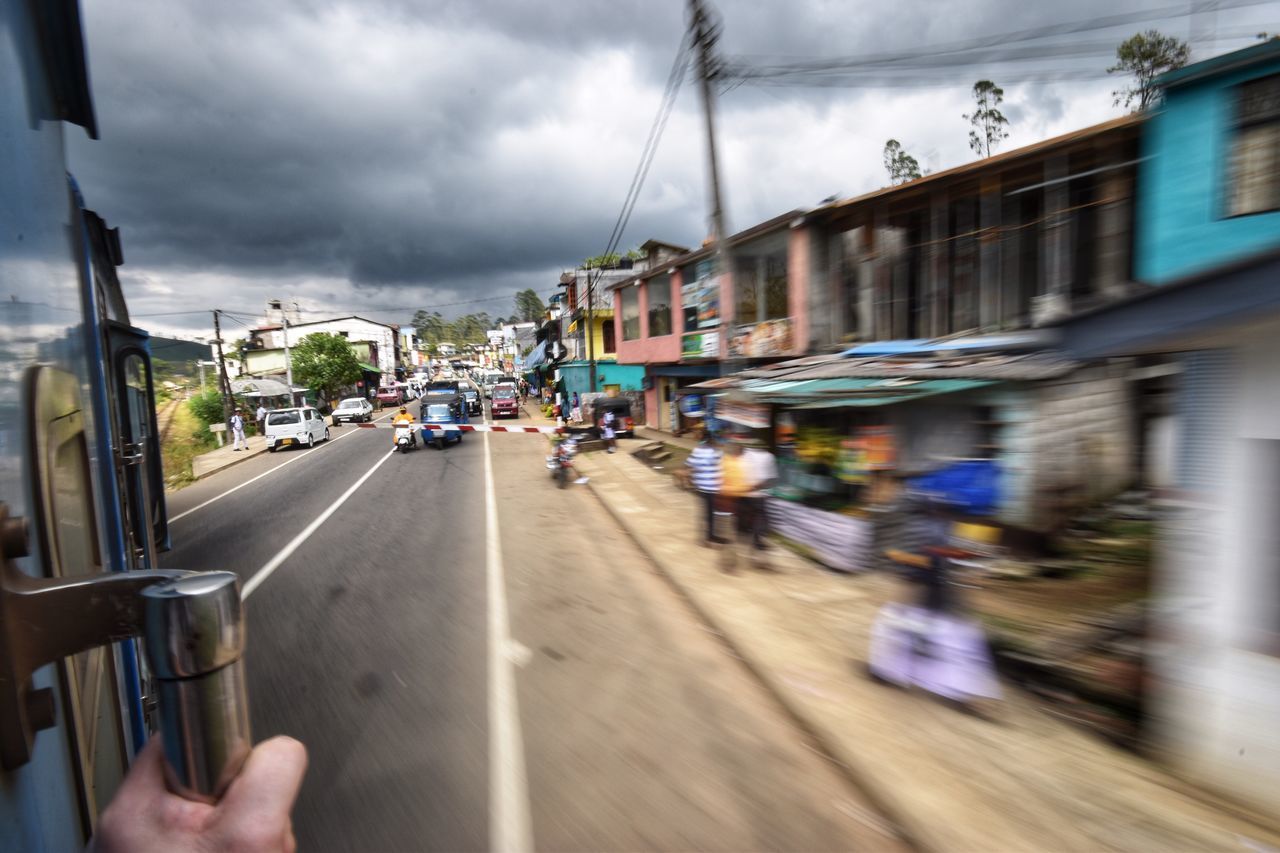 BLURRED MOTION OF VEHICLES ON STREET IN CITY