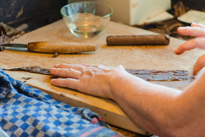 Cropped image of woman preparing food on table