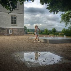 Full length of woman standing in water