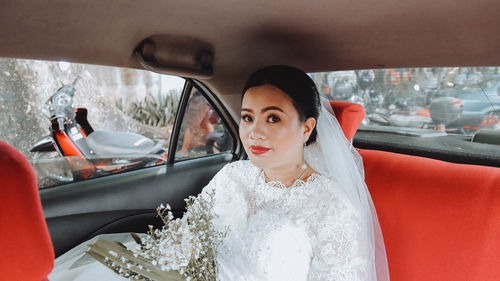 Portrait of young woman in car