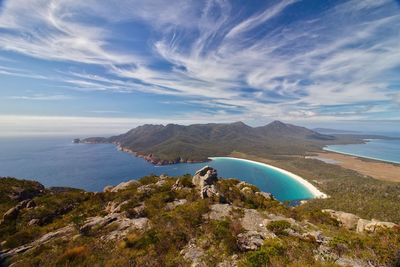 Scenic view of sea and mountains against sky