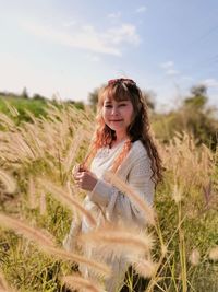 Portrait of smiling young woman on field