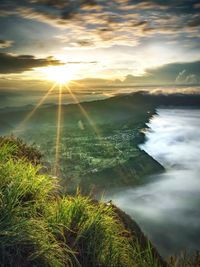 Scenic view of land against sky during sunset