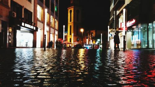 Reflection of illuminated buildings in city at night