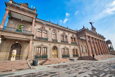 Low angle view of historical building against cloudy sky