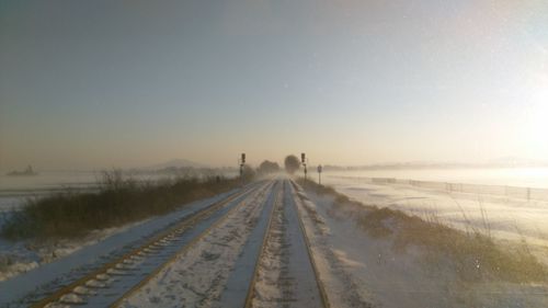 Scenic view of frozen landscape against clear sky during winter