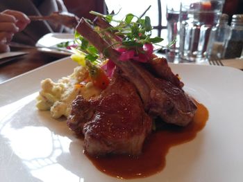 Close-up of hand holding food in plate