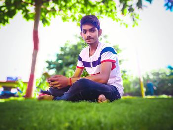 Portrait of man sitting on land