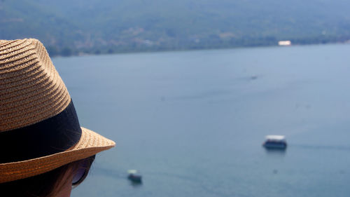 Close-up of hat on beach against sky