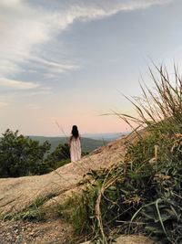 Rear view of woman looking at sea against sky