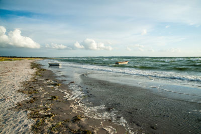 Scenic view of beach and sea against sky