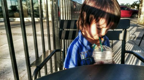 Close-up of boy drinking outdoors