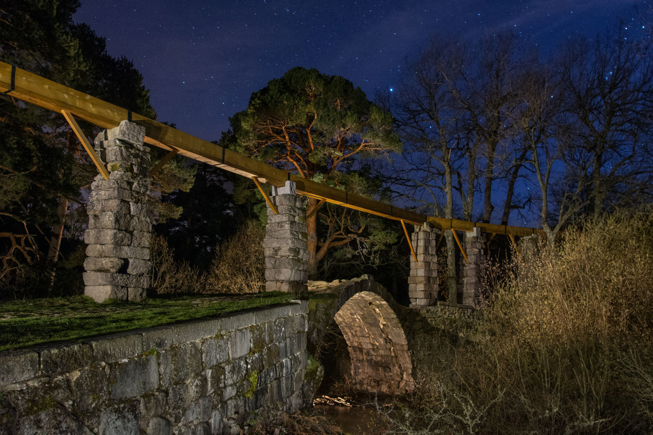 BRIDGE AGAINST SKY AT NIGHT