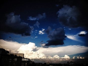 Buildings against cloudy sky