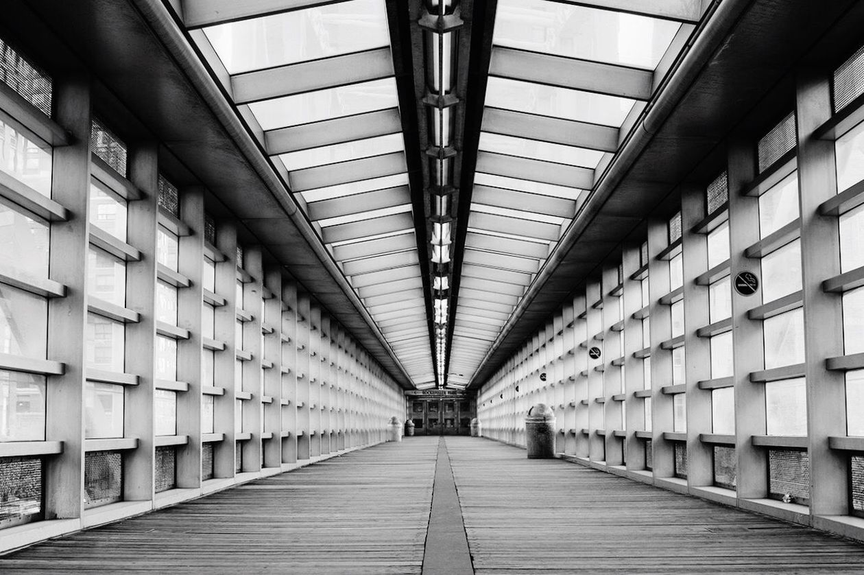 indoors, the way forward, ceiling, architecture, diminishing perspective, built structure, corridor, empty, vanishing point, in a row, building, long, narrow, lighting equipment, flooring, modern, absence, interior, illuminated, no people