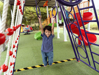 Full length of boy playing in playground