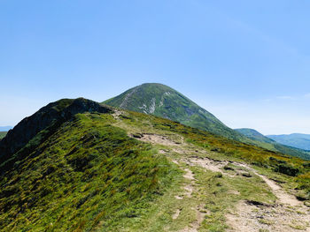 Scenic view of mountains against clear blue sky