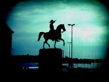 Low angle view of statue against cloudy sky