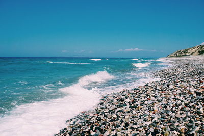 Scenic view of sea against blue sky