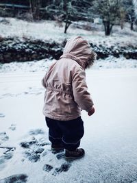 Side view of person wearing hat on field during winter