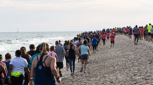 Rear view of people on beach