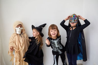 Kids in halloween costumes on white background