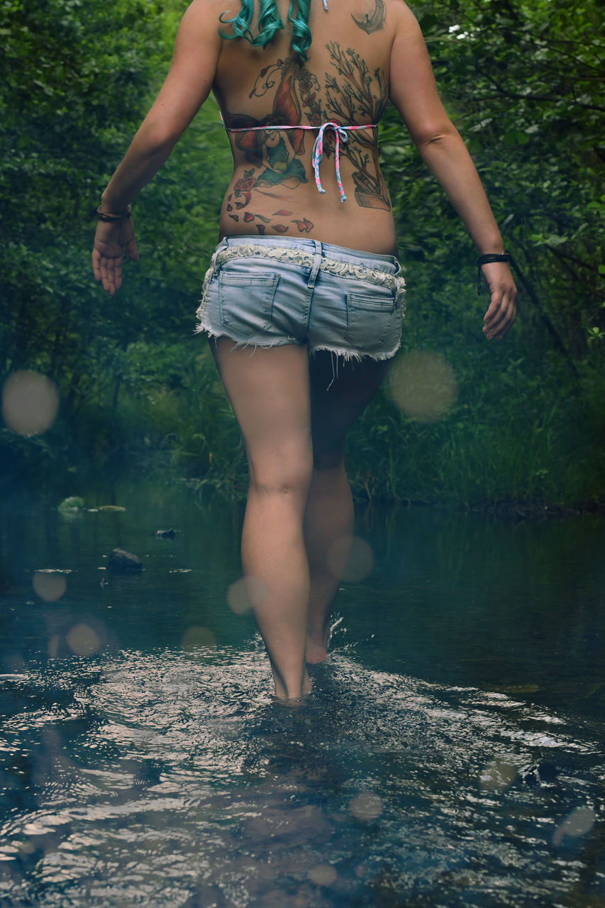 water, women, lifestyles, leisure activity, real people, one person, nature, human body part, body part, low section, day, limb, plant, human leg, adult, land, clothing, outdoors, human limb, shorts