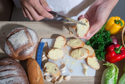 Midsection of man applying butter on bread