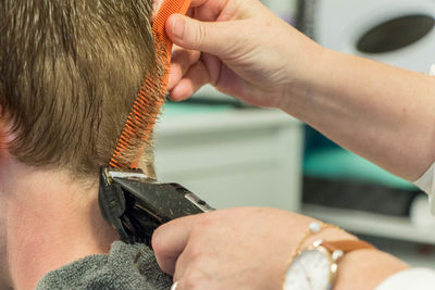 Male customer having haircut at salon