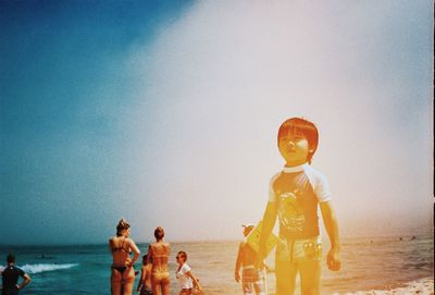 People on beach against sky