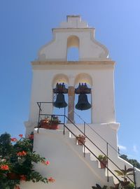 Low angle view of old bells against sky