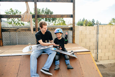 Skateboarding instructor and student high five