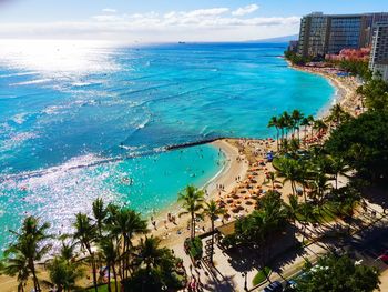 Aerial view of blue sea on sunny day in city