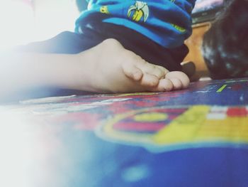 Close-up of baby playing with tattoo on table