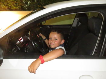 Portrait of girl sitting in car