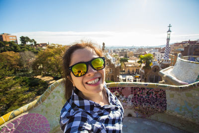 Portrait of smiling man wearing sunglasses against sky